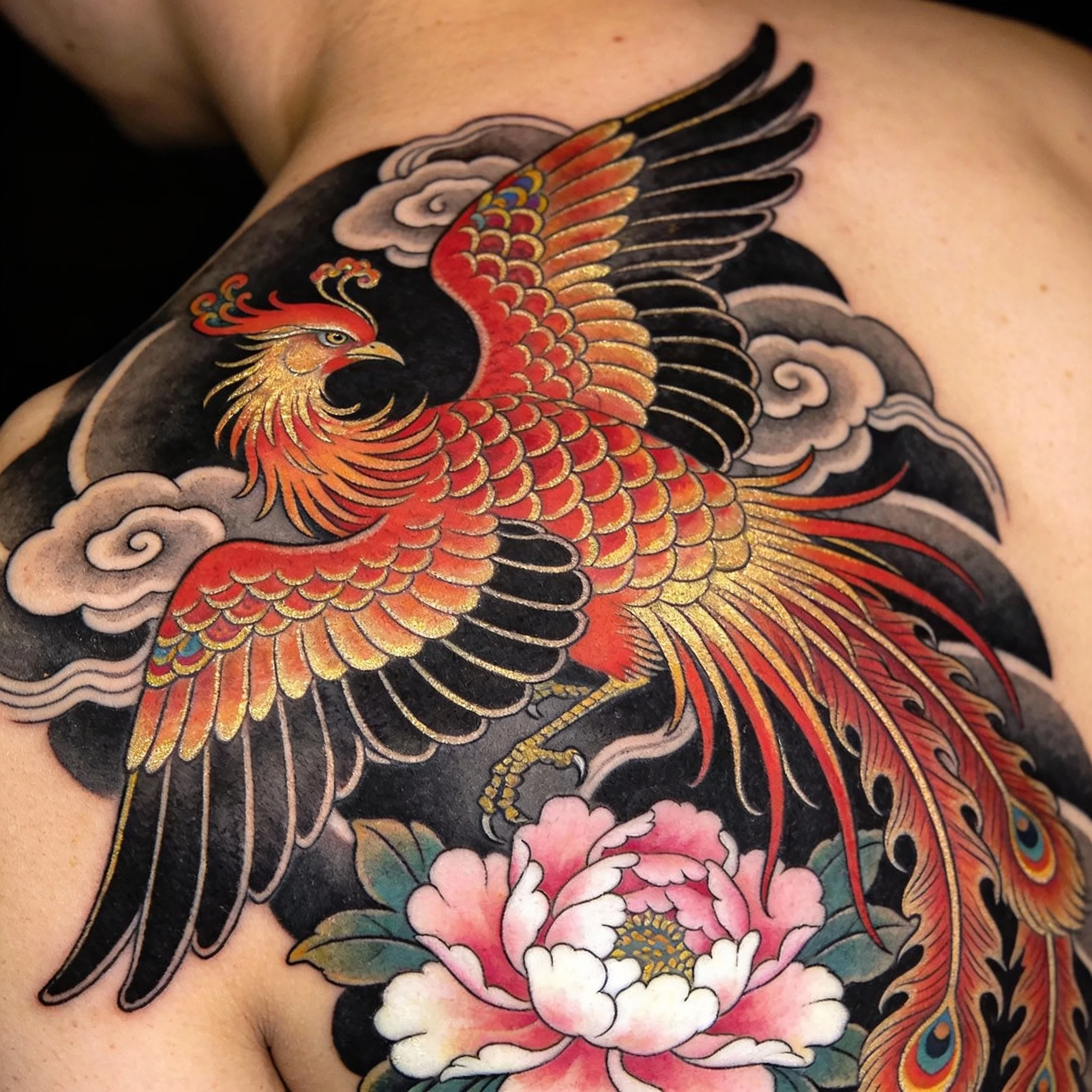 Japanese Fenghuang phoenix tattoo with elaborate plumage and cloud scrolls