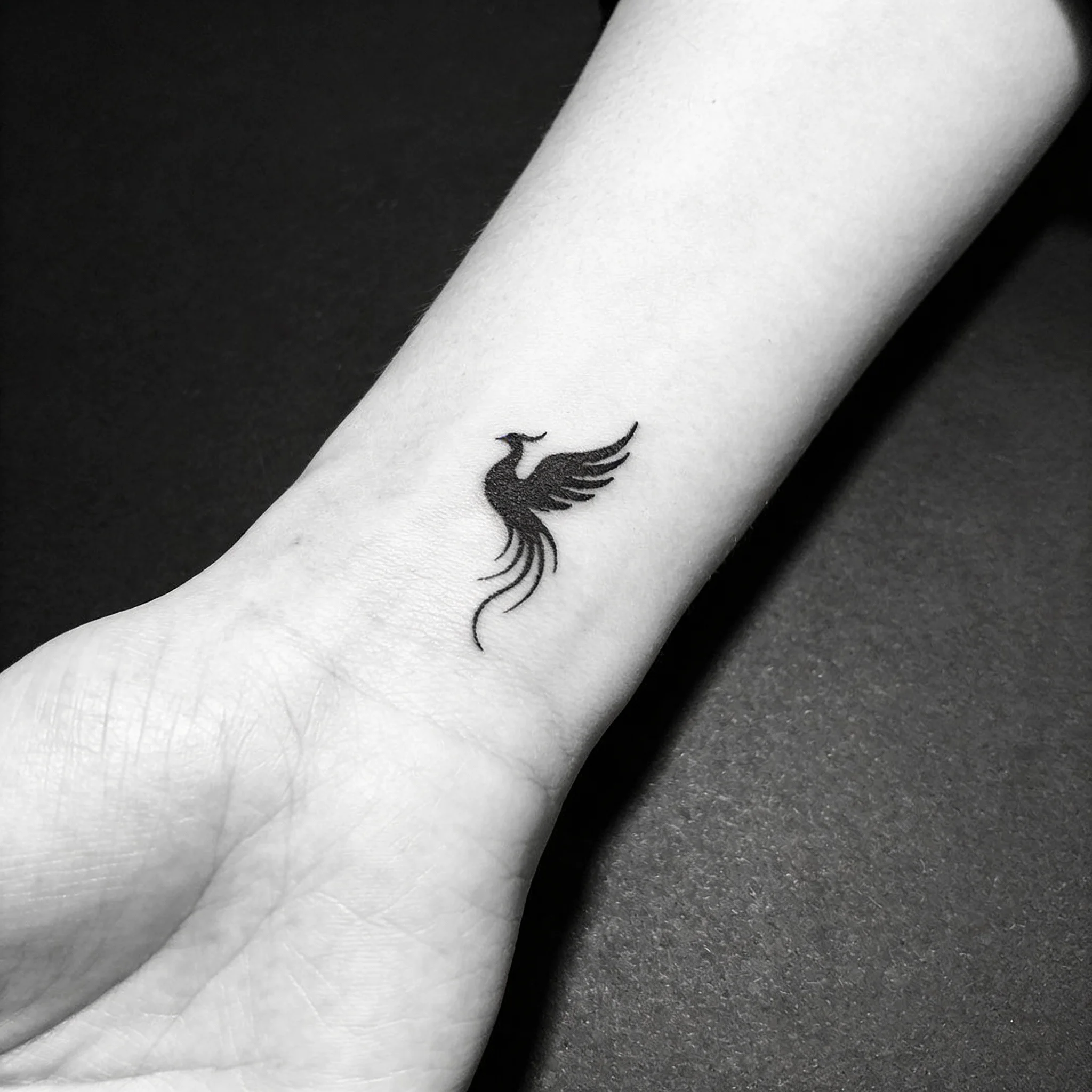 Minimalist phoenix tattoo with fine line work