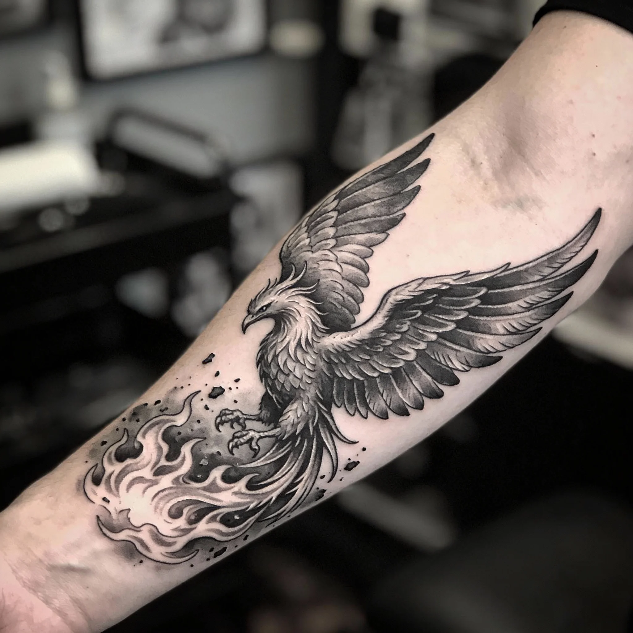 Phoenix rebirth tattoo showing bird rising from flames